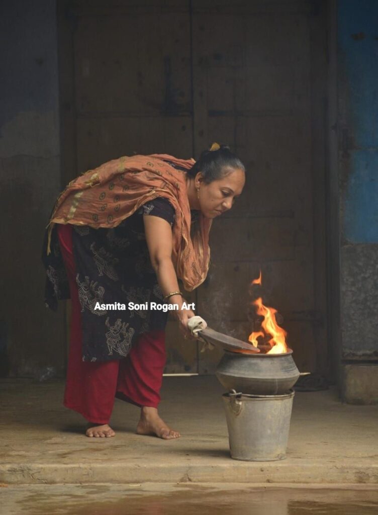 Komal Ashish Kansara carefully boils castor oil for Rogan paste