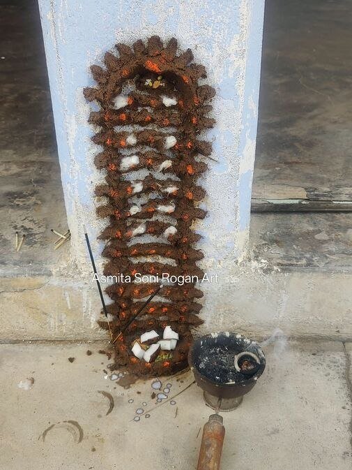 Goga Dada figure on the wall of doorstep using cow dung